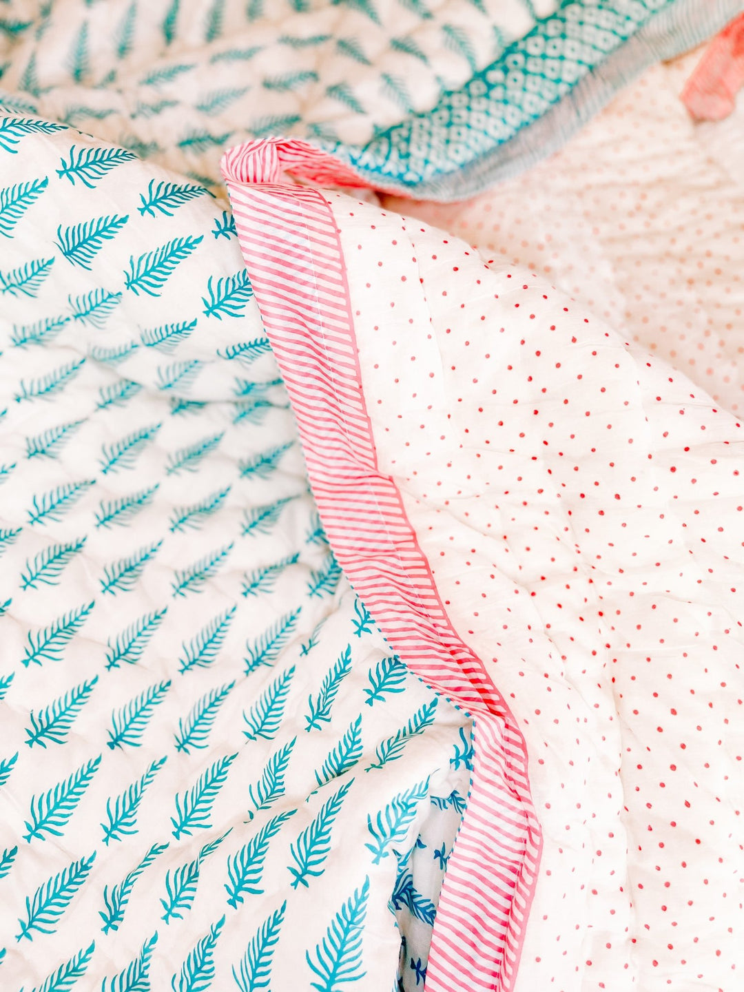 Bombaby block print indian reversible quilt. Pink spots and blue leaf print bedding. Handmade and ethically sourced.